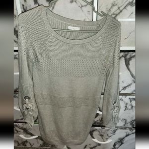 Grey knit sweater with ties at the forearm